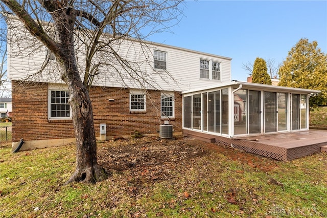 rear view of property with a sunroom, a patio, and central air condition unit