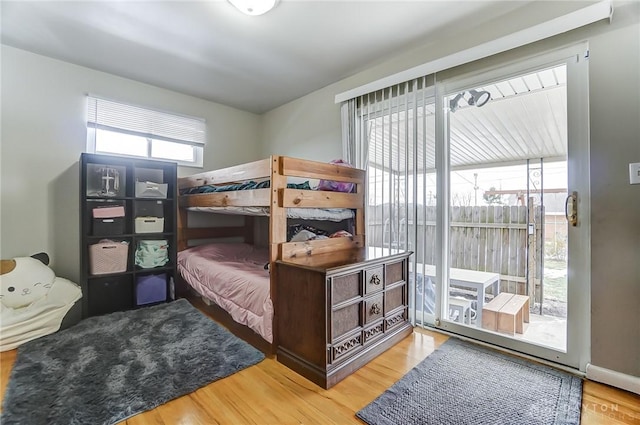 bedroom featuring light hardwood / wood-style flooring and access to outside