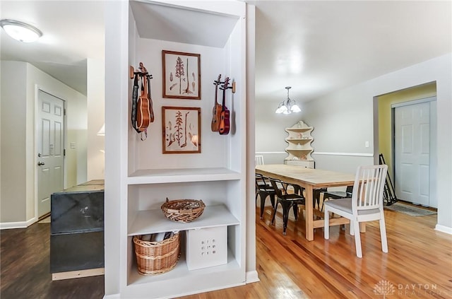 dining room featuring hardwood / wood-style flooring and an inviting chandelier