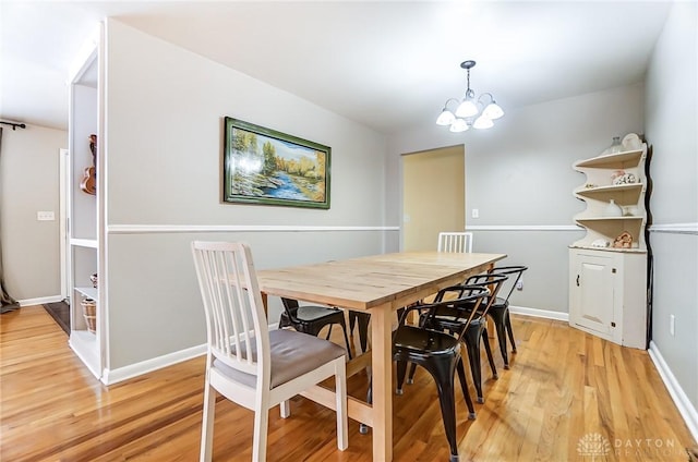 dining room featuring an inviting chandelier and light hardwood / wood-style flooring