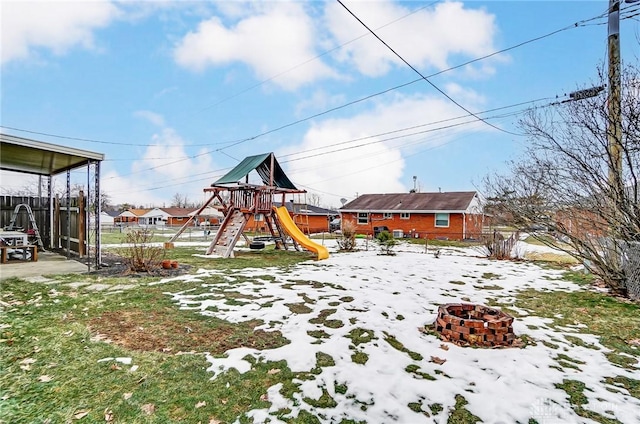 snow covered playground with an outdoor fire pit