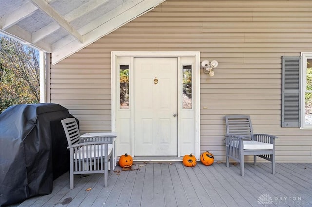 view of exterior entry with a deck