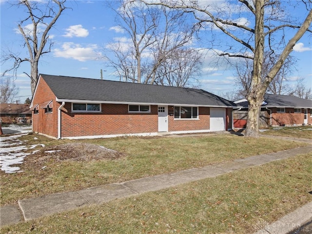 ranch-style home with a garage and a front lawn