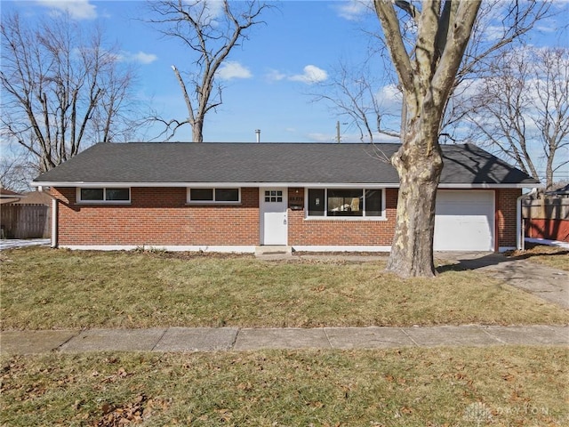 single story home featuring a garage and a front lawn