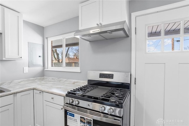 kitchen featuring white cabinetry, electric panel, light stone counters, and stainless steel gas stove