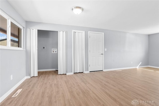 unfurnished room featuring light hardwood / wood-style floors