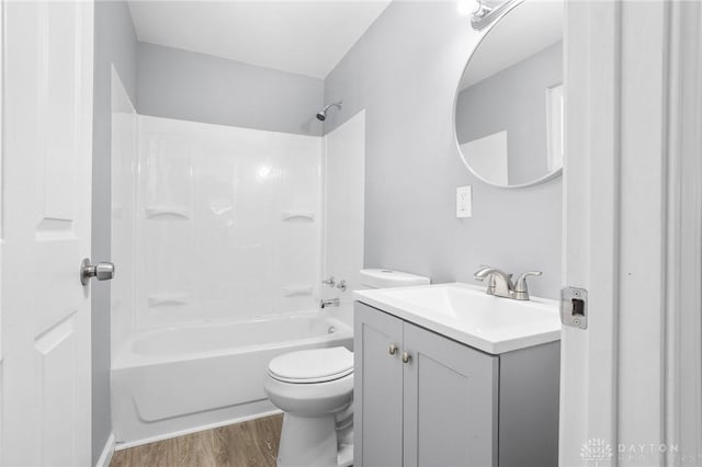 full bathroom featuring vanity, toilet, bathing tub / shower combination, and hardwood / wood-style floors