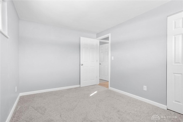 spare room with light colored carpet