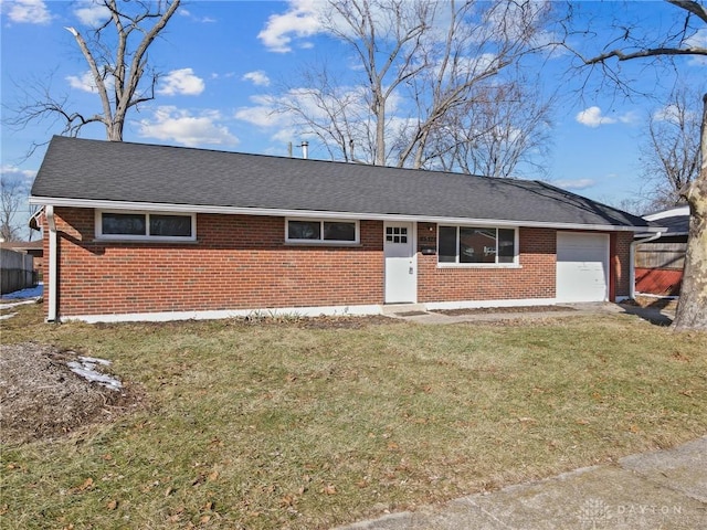 ranch-style home with a garage and a front lawn