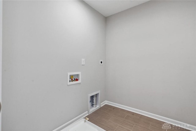 laundry room featuring hookup for a washing machine, gas dryer hookup, electric dryer hookup, and hardwood / wood-style flooring