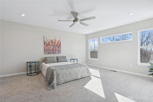 bedroom with light colored carpet and ceiling fan