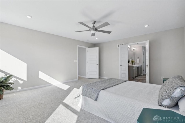 carpeted bedroom featuring ceiling fan and connected bathroom