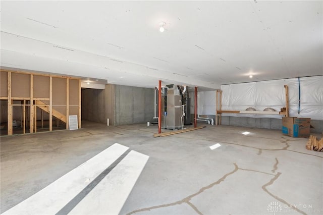 basement with water heater and heating unit