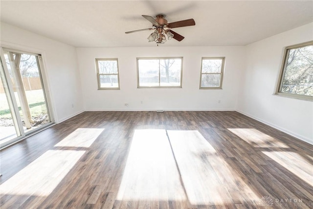 empty room featuring ceiling fan and dark hardwood / wood-style floors