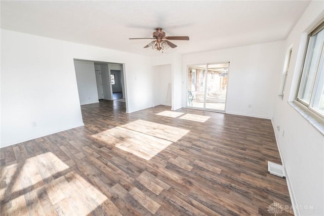 spare room with ceiling fan and dark hardwood / wood-style floors