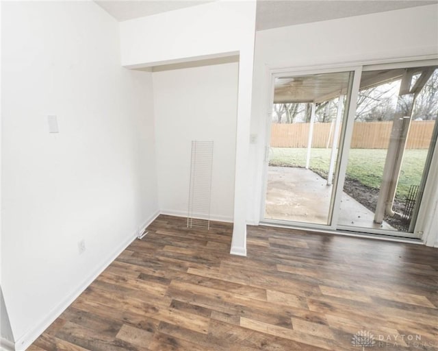 spare room with dark hardwood / wood-style floors