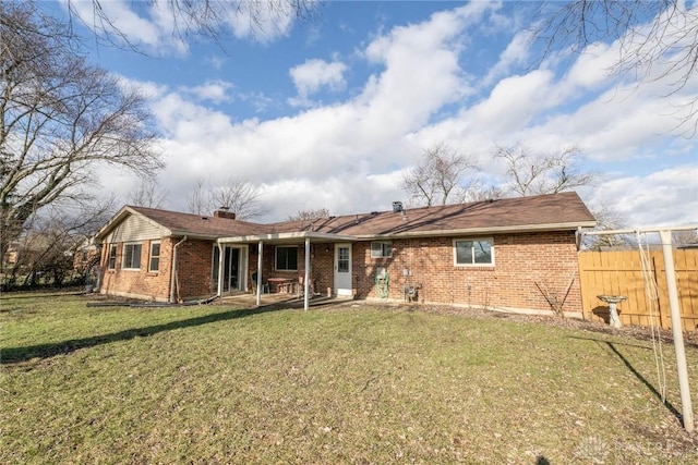 rear view of property with a lawn