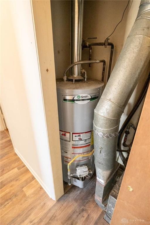 utility room featuring water heater