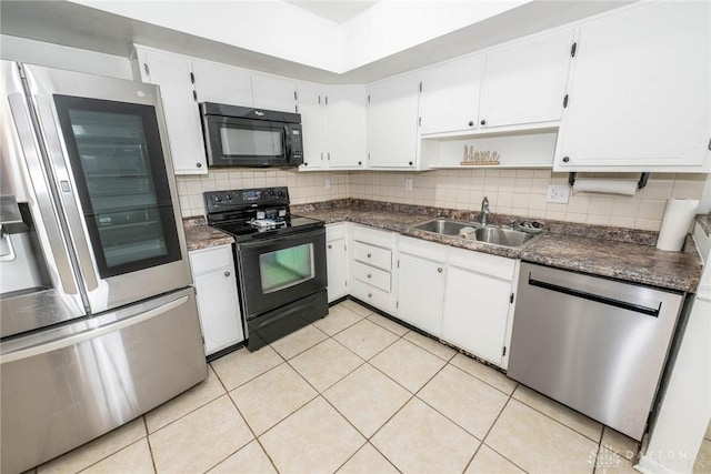 kitchen featuring light tile patterned flooring, tasteful backsplash, sink, white cabinets, and black appliances