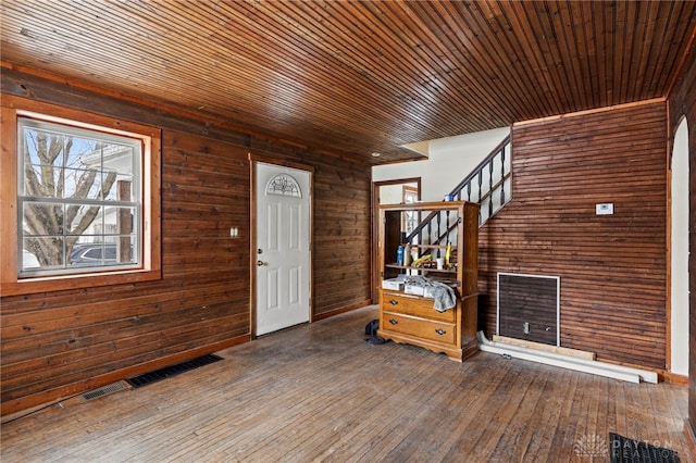 foyer featuring hardwood / wood-style floors, wooden walls, and wooden ceiling