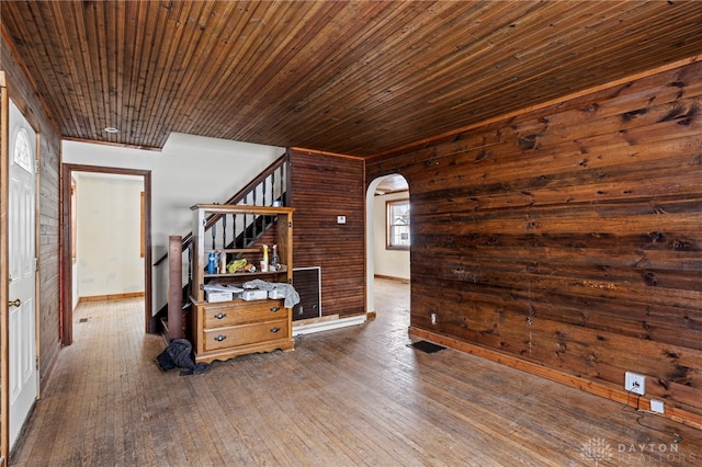 empty room with dark wood-type flooring and wood ceiling