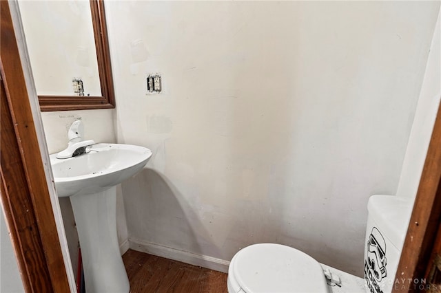 bathroom featuring sink, hardwood / wood-style flooring, and toilet