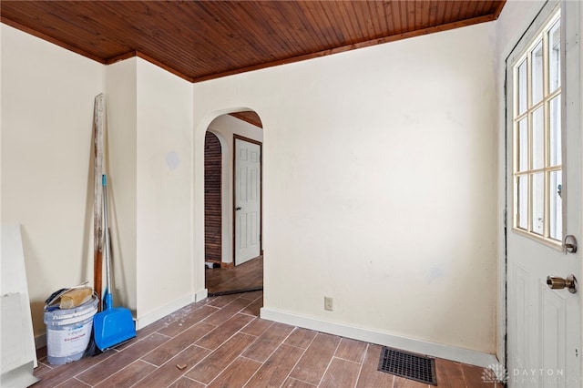 spare room featuring crown molding and wooden ceiling