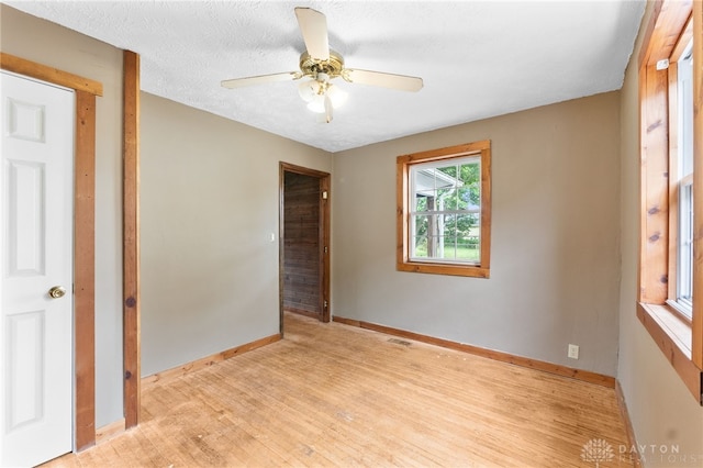 700 James St, Springfield, OH 45503 - unfurnished bedroom with light wood-type flooring, baseboards, and a ceiling fan