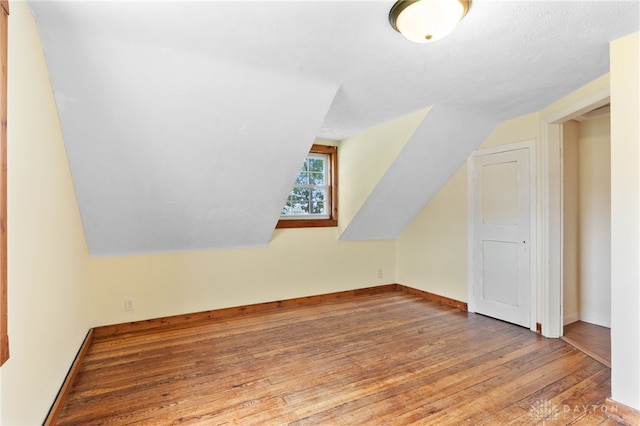 700 James St, Springfield, OH 45503 - bonus room featuring wood-type flooring, vaulted ceiling, and baseboards