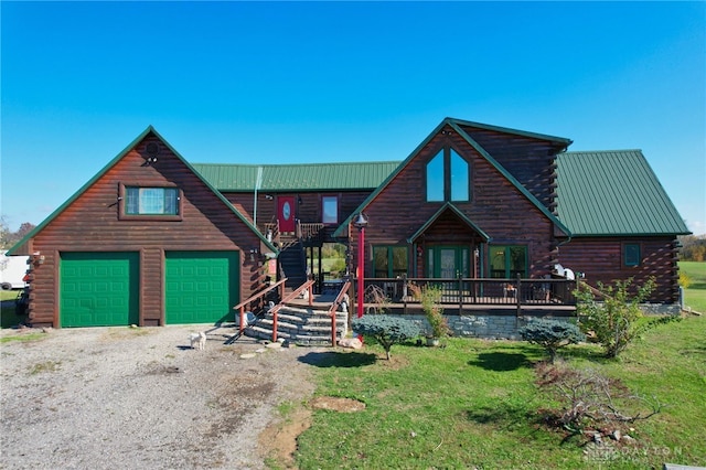 cabin with a garage and a front yard