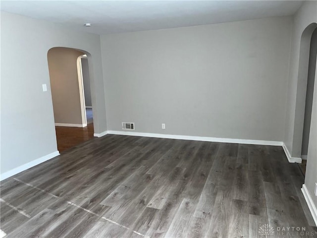 unfurnished room with dark hardwood / wood-style flooring