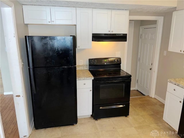 kitchen with light stone countertops, white cabinets, and black appliances