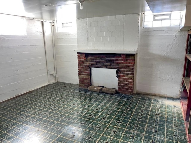 basement with a brick fireplace and a wealth of natural light