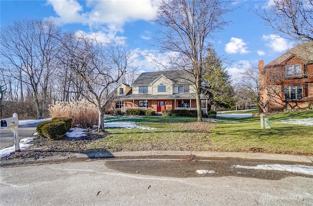 cape cod house featuring a front lawn