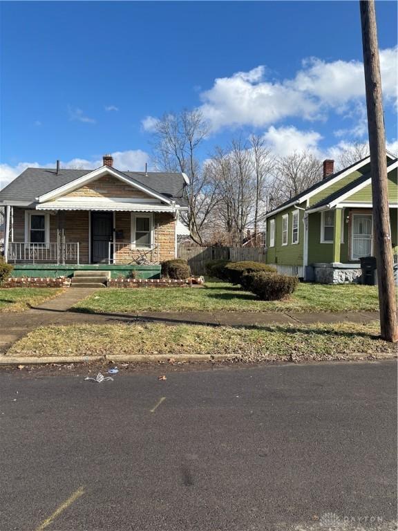 bungalow-style home with a front lawn