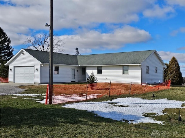 ranch-style home with a yard and a garage