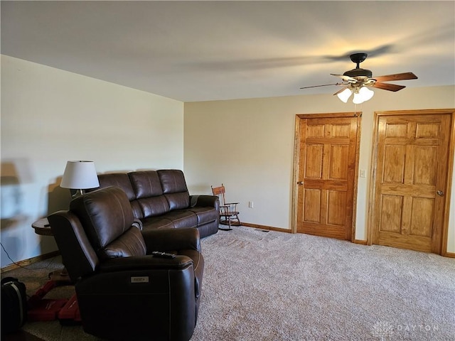 carpeted living room with ceiling fan