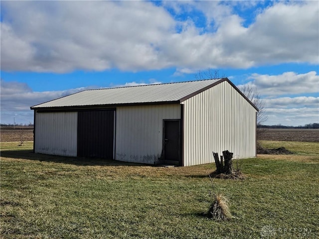 view of outbuilding with a yard