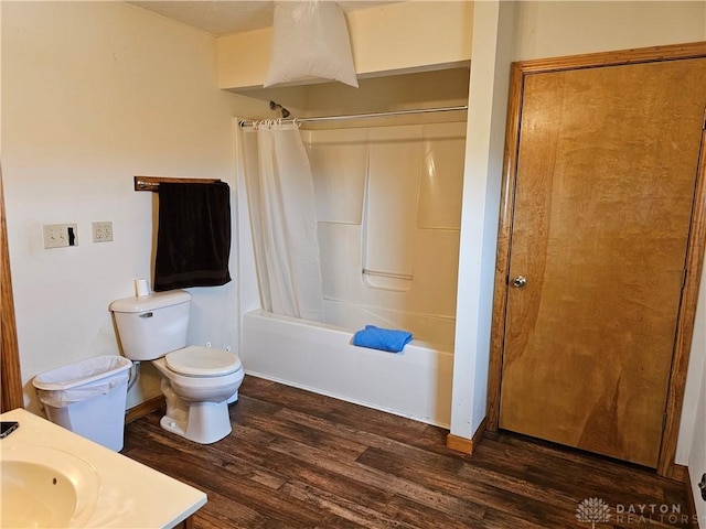 full bathroom with wood-type flooring, vanity, shower / tub combo, and toilet