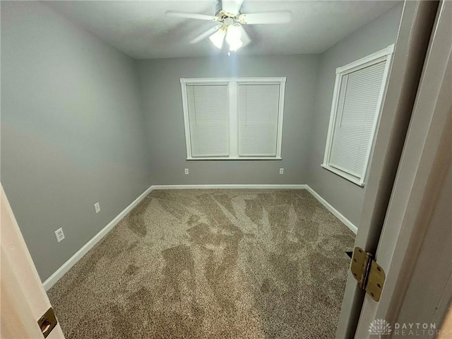 empty room with carpet floors and ceiling fan