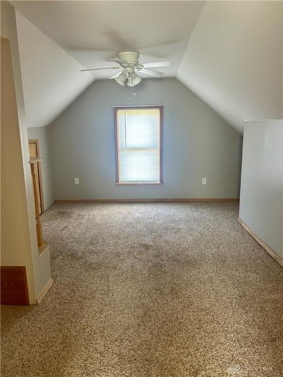 bonus room featuring ceiling fan, lofted ceiling, and carpet flooring