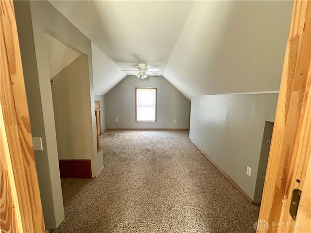 additional living space with vaulted ceiling and carpet