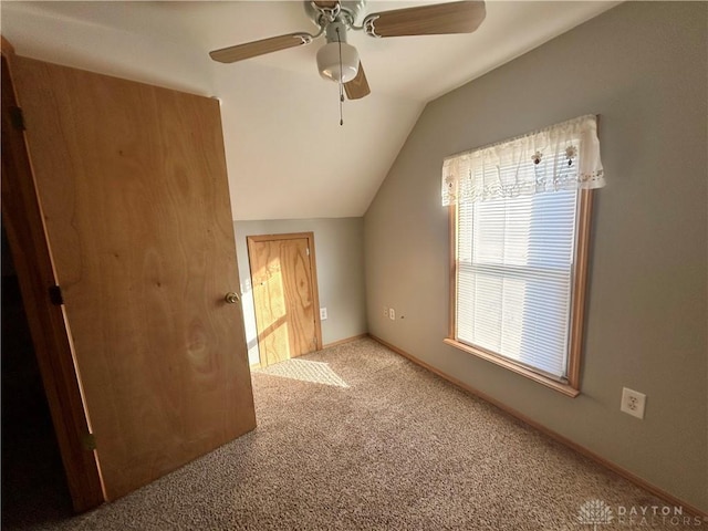 bonus room featuring ceiling fan, vaulted ceiling, and light carpet