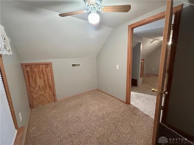 additional living space with ceiling fan, lofted ceiling, and carpet flooring