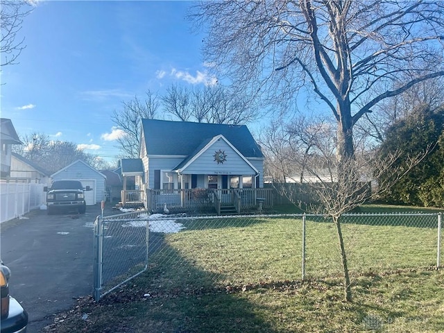 view of front of home with an outbuilding, a garage, a front yard, and covered porch