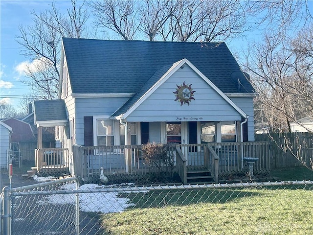 bungalow with covered porch and a front lawn