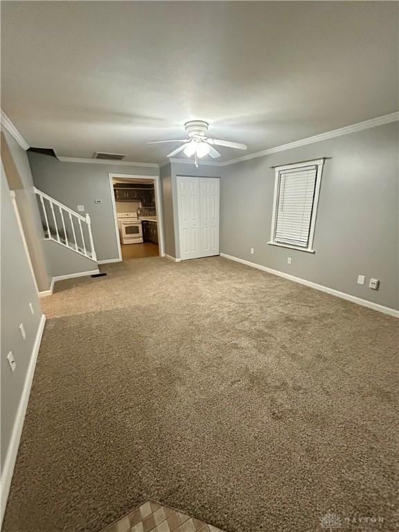 interior space with ornamental molding and ceiling fan