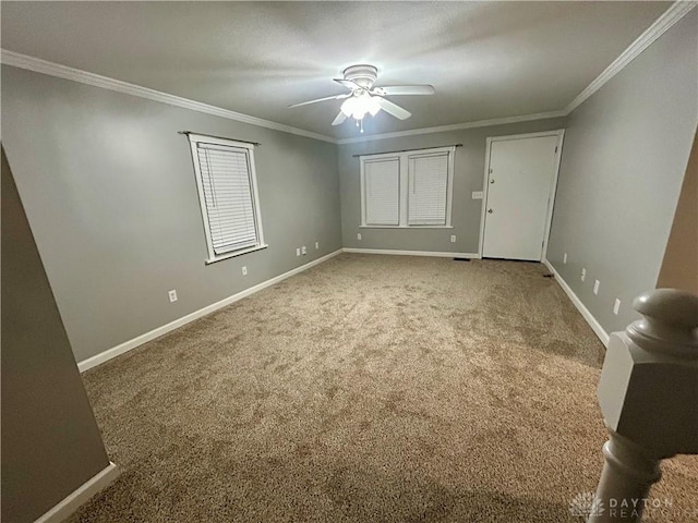 spare room with crown molding, ceiling fan, and carpet