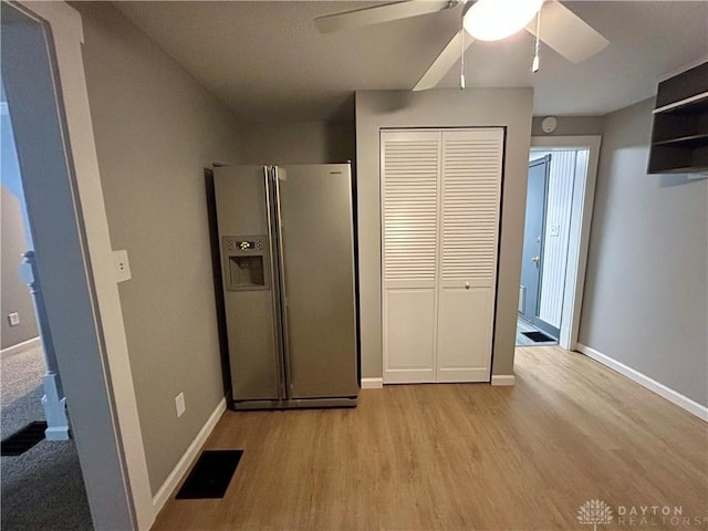 interior space with stainless steel fridge with ice dispenser, light hardwood / wood-style flooring, and ceiling fan