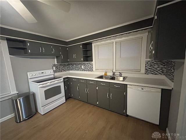 kitchen with sink, white appliances, dark hardwood / wood-style floors, and decorative backsplash